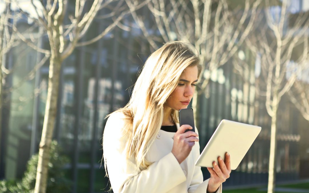 A woman studies her tablet.